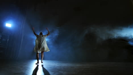 Slow-motion:-female-dancer-on-stage-in-smoke.-Modern-ballet-barefoot-on-stage.